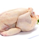 A whole chicken displayed, highlighting quality and freshness from The National Halal Meat, ready for cooking