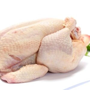 A whole chicken displayed, highlighting quality and freshness from The National Halal Meat, ready for cooking
