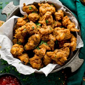 Crispy chicken pakoras served in a square dish, showcasing flavorful bites that highlight quality and taste from The National Halal Meat