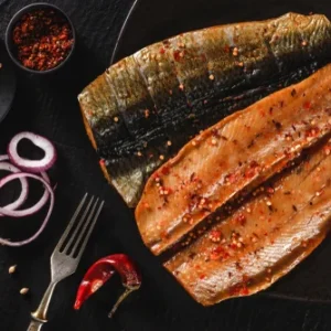 Delicious marinated fish fillets, showcasing vibrant spices and flavors, highlighting quality offerings from The National Halal Meat